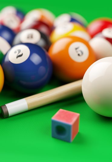Group of billiard colored balls, cue and chalk on green table. 3d illustration
